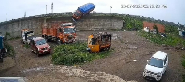 Truck overturns after hitting